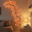 Decorative wall light fixture shaped like a branch with lights in a bedroom setting, Obroi