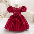 Red dress with puff sleeves on a mannequin against a decorative background, Obroi