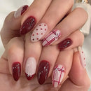 Hand with burgundy and white nail art on a neutral background, Obroi