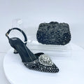 Black studded high-heeled shoes with a matching handbag on a white background, Obroi