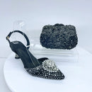 Black studded high-heeled shoes with a matching handbag on a white background, Obroi