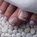 Nails with floral design on a white stone surface, Obroi