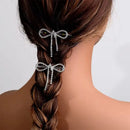 Hair accessories with bow design in a braided hairstyle on a plain background, Obroi