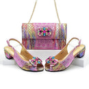 Pair of pink high-heeled shoes with colorful embellishments and a matching handbag on a white background, Obroi
