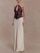 Woman wearing a black lace top and white skirt against a plain background, Obroi