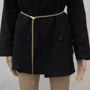 Black coat with gold zipper on a mannequin against a neutral background, Obroi