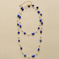 Necklace with blue and white beads on a beige background, Obroi