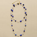 Necklace with blue and white beads on a beige background, Obroi