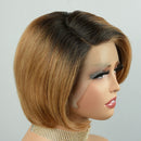 A short bob wig with a dark brown to warm blonde ombré colorway, styled on a mannequin head against a light gray background, Obroi