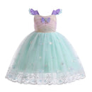 A children's mermaid-style party dress with a lavender bodice, purple shoulder straps, a glittery gold waistband, and a voluminous mint green tulle skirt decorated with shell and star motifs, Obroi