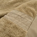 Close-up of a beige textured fabric with stitching detail, Obroi