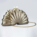 Shell-shaped handbag with a gold chain on a light gray background, Obroi