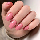 Hand with pink nail polish on a neutral background, Obroi