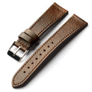 Brown leather watch strap with silver buckle on a white background, Obroi