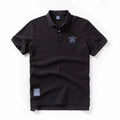 Black polo shirt with a small logo on a white background, Obroi