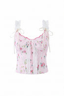 A pink floral corset-style top with white lace trim, white shoulder ties, and a white lace front bow, shown on a plain white background. A Obroi brand label is visible in the top-left corner.