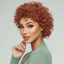 Woman with styled red hair against a light gray background, Obroi