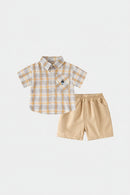 A two-piece baby boy's outfit set by iyeal, featuring a short-sleeve plaid button-up shirt in beige, white, and yellow-orange, paired with solid beige shorts, Obroi