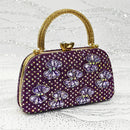 Purple handbag with floral patterns and gold accents on a glittery background, Obroi