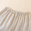 Close-up of beige fabric with an elastic waistband on a beige background, Obroi