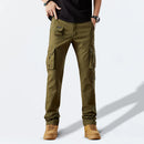 Person wearing olive green cargo pants on a white background, Obroi