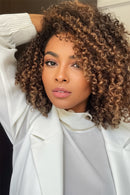 Woman with curly hair wearing a white outfit, Obroi
