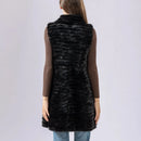 Person wearing a black fur vest on a plain background, Obroi