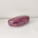 Marbled pink and purple glasses case on a white surface, Obroi