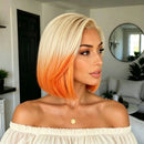 A woman with a short, straight bob haircut featuring a blonde top half and a bright orange ombre bottom half, wearing an off-the-shoulder cream top in a modern living room setting, Obroi