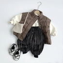 Children's outfit with brown puffer vest, striped pants, and white shirt on a hanger against a light gray background, Obroi
