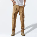 Person wearing beige cargo pants on a white background, Obroi