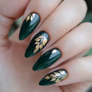 Green nails with gold leaf designs on a hand, Obroi