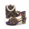 Purple high-heeled shoes with gold accents and a matching clutch on a white , Obroi