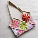 Colorful crocheted bag with floral patterns on a light gray background, Obroi