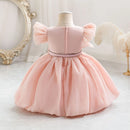 Pink dress on a mannequin against a decorative background, Obroi
