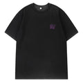 Black t-shirt with a small logo on the chest against a white background, Obroi
