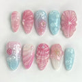 Set of decorative nail art designs in pink and blue on a white background, Obroi