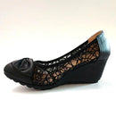 Black wedge shoe with lace detailing on a white background, Obroi