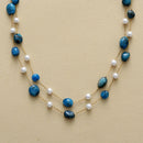 Necklace with blue beads and gold chain on a beige background, Obroi