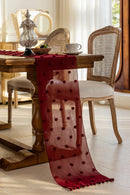 Red polka dot table runner draped over a wooden table in a dining room setting, Obroi