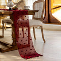 Red polka dot table runner draped over a wooden table in a dining room setting, Obroi