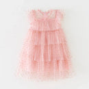 A pink tiered tulle dress for toddlers, featuring a delicate gold polka dot pattern and ruffled cap sleeves, laid flat against a white background, Obroi