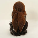 Brown hair bun with a decorative bow on a beige background, Obroi