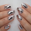 Silver metallic nail polish on a person's fingernails against a white background, Obroi