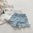Light blue denim shorts with ruffled edges on a light background, Obroi