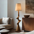 Wooden floor lamp in a living room setting with a sofa and side table, Obroi
