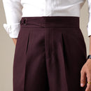 Maroon pleated pants worn with a white shirt on a neutral background, Obroi