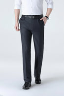 Person wearing dark gray dress pants on a white background, Obroi