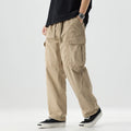 Person wearing beige cargo pants on a white background, Obroi