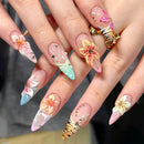 Close-up of hands with intricately designed floral and animal print nails, Obroi